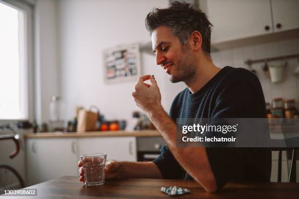 man taking medicine - tablet close up real copyspace stock pictures, royalty-free photos & images