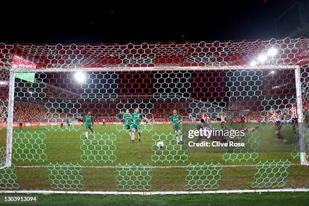 Mads Bech Sorensen of Brentford scores their team's third goal past Joe Wildsmith of Sheffield Wednesday during the Sky Bet Championship match...