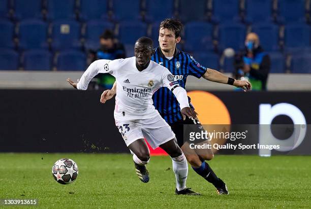 Marten de Roon of Atalanta BC competes for the ball with Ferland Mendy of Real Madrid during the UEFA Champions League Round of 16 match between...