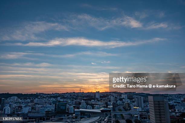 morning sunbeam on the residential district on the hill in naha city of japan - sunrise ストックフォトと画像