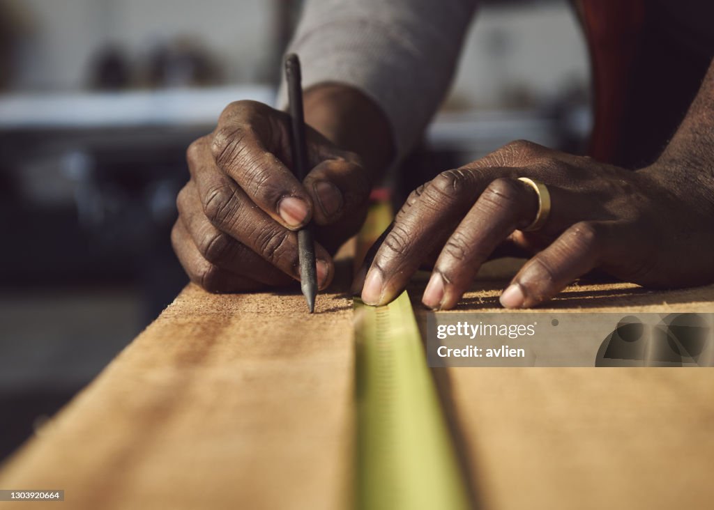 Cropped Hands Of Carpenter Working At Workshop