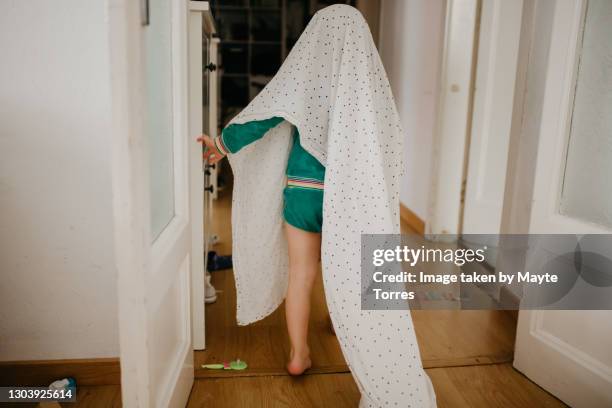 boy playing with a sheet pretending to be a ghost - ghost photos et images de collection