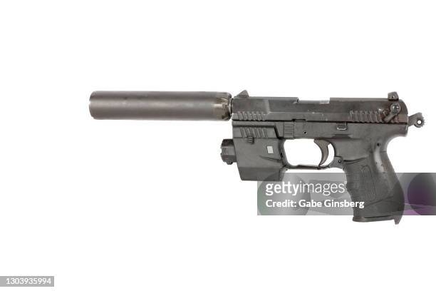guns : close up of a subcompact .22 caliber handgun with a silencer and laser sight on a white background - silencer stock pictures, royalty-free photos & images