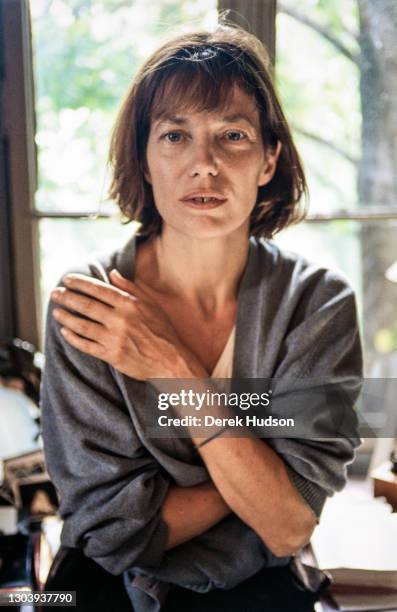 Jane Mallory Birkin, OBE poses in a white T-short and oversize pale blue cardigan for informal portraits at her former home in the 16th...