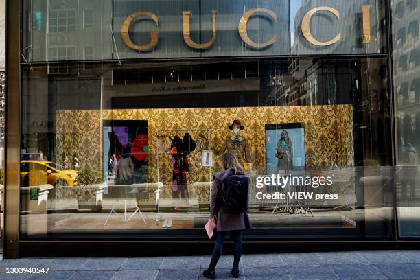 Woman looks at a shopwindow of the Gucci store on Fifth Avenue in Trump Tower on February 24, 2021 in New York City. Gucci extended its lease in...