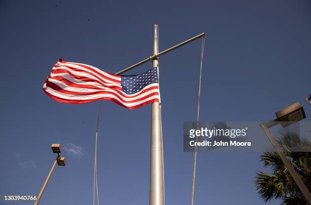 The U.S. Flag flies at half staff at the port of entry at the U.S.-Mexico border on February 24, 2021 in Brownsville, Texas. U.S. President Joe Biden...