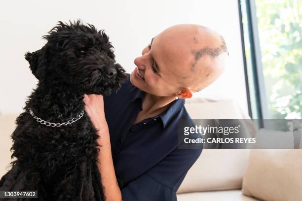 young woman stroking her dog - hair loss in woman stock pictures, royalty-free photos & images