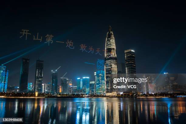 Hundreds of unmanned aerial vehicles perform in formation over Shenzhen bay to commemorate the 100th anniversary of the founding of the Communist...