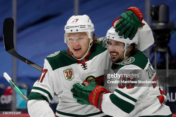 Kirill Kaprizov of the Minnesota Wild congratulates Mats Zuccarello after his goal against the Colorado Avalanche in the first period at Ball Arena...