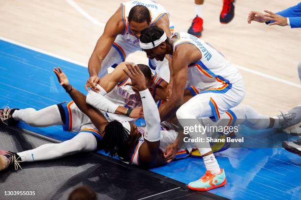 Luguentz Dort of the Oklahoma City Thunder is dog piled by his teammates after hitting a three pointer at the buzzer to defeat the San Antonio Spurs...