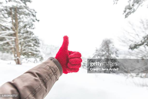 winter happiness thumbs up personal perspective - red glove stock pictures, royalty-free photos & images