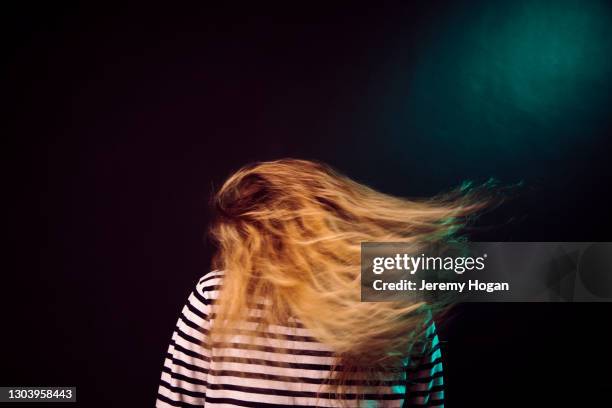 woman shaking her head with her hair flying - headbanging stock pictures, royalty-free photos & images