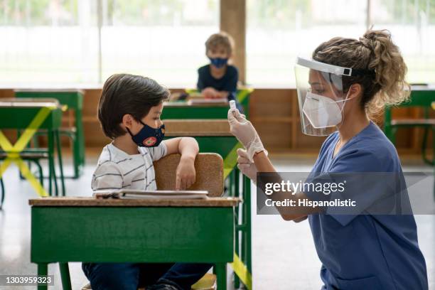 covid-19 vaccination day at school - global health stock pictures, royalty-free photos & images