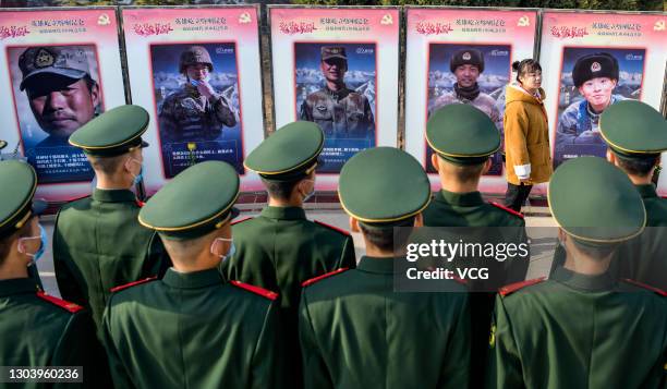 Soldiers of local People's Armed Police Force pay respects to four martyrs, who died during the border clash with India in June, at a martyrs...