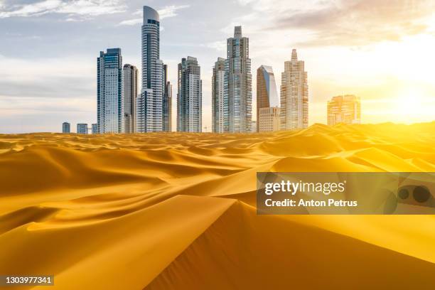 skyscrapers in the desert. the concept of globalization and global warming - qatar stock-fotos und bilder