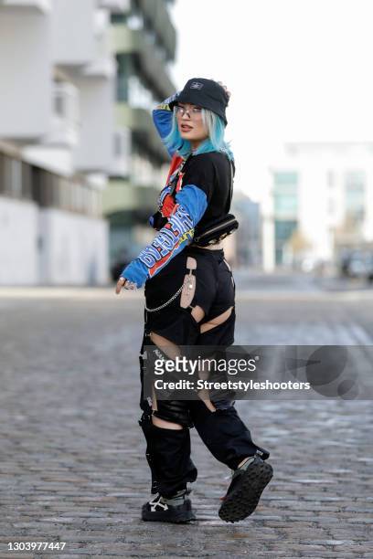 Influencer and Content Creator Naomi Jon wearing a black bucket hat by Asos, vintage glasses with silver crystal details, black nylon and black vegan...