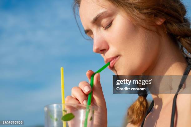 woman enjoying a mojito - straw lips stock pictures, royalty-free photos & images