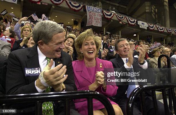 Senators Christopher "Kit" Bond , left, and John Ashcroft clap for republican presidential candidate George W. Bush with Ann Wagner, center, chairman...