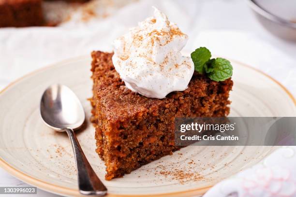 slice of carrot cake on table - carrot cake stock pictures, royalty-free photos & images