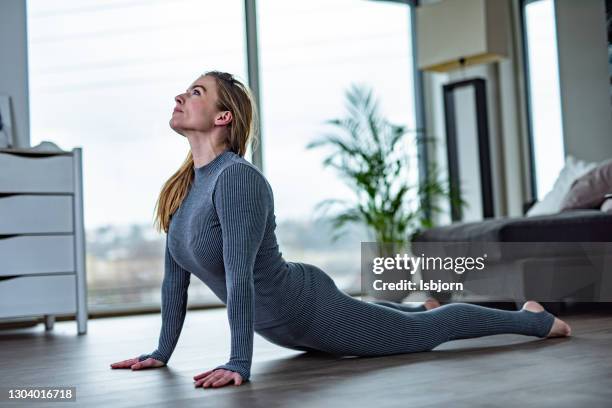 mid adult sporty woman trainer do practice individual hatha yoga instructor training bhujangasana pose high cobra posture . - norway womens training session stock pictures, royalty-free photos & images