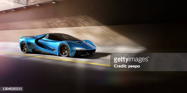 blue sports car about to travel through tunnel at speed - carro desportivo imagens e fotografias de stock