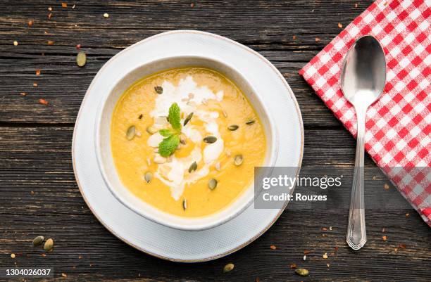 pumpkin, carrot cream soup in a bowl. - cream soup stock pictures, royalty-free photos & images