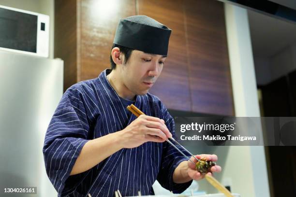 a japanese sushi chef making sushi - sushi chef stock pictures, royalty-free photos & images