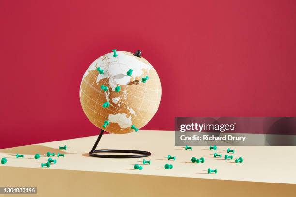 a world globe marked with push pins - puntina da disegno foto e immagini stock