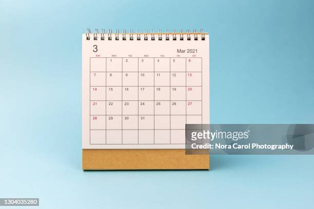 march 2021 desk calendar on blue background - calendar stock pictures, royalty-free photos & images