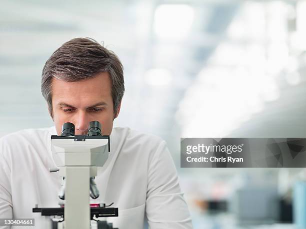 scientist using microscope in lab - microscope stock pictures, royalty-free photos & images