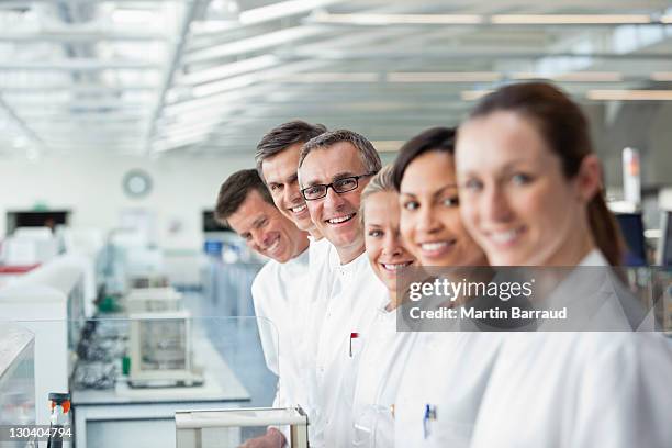 scientists smiling together in lab - wetenschapper stockfoto's en -beelden