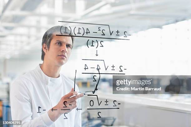 scientist using touch screen in lab - mathematician stock pictures, royalty-free photos & images