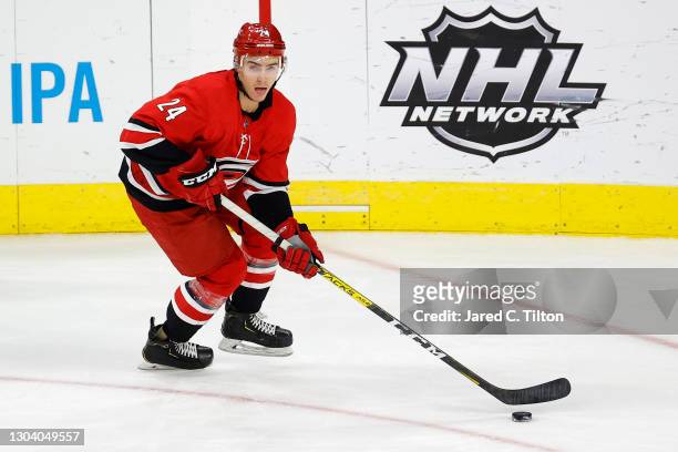 Jake Bean of the Carolina Hurricanes looks to pass during the third period of their game against the Tampa Bay Lightning at PNC Arena on February 22,...