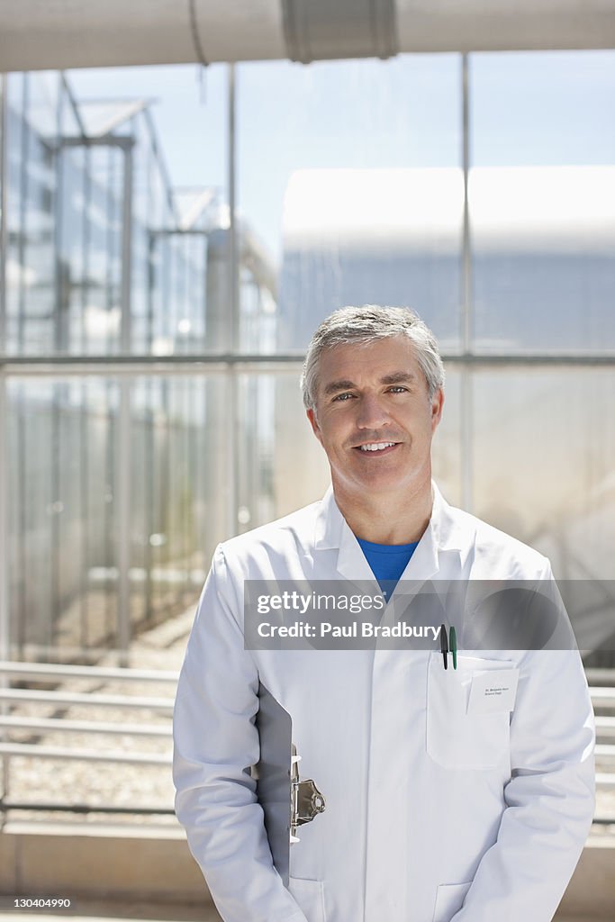 Scientist carrying clipboard in lab