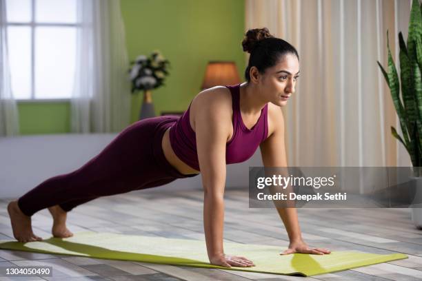 young woman doing yoga at home, stock photo - press ups stock pictures, royalty-free photos & images