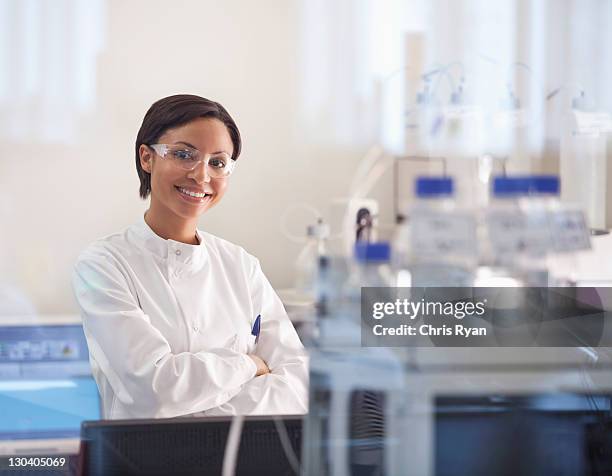 scientist wearing protective glasses in lab - scientist in lab stock pictures, royalty-free photos & images