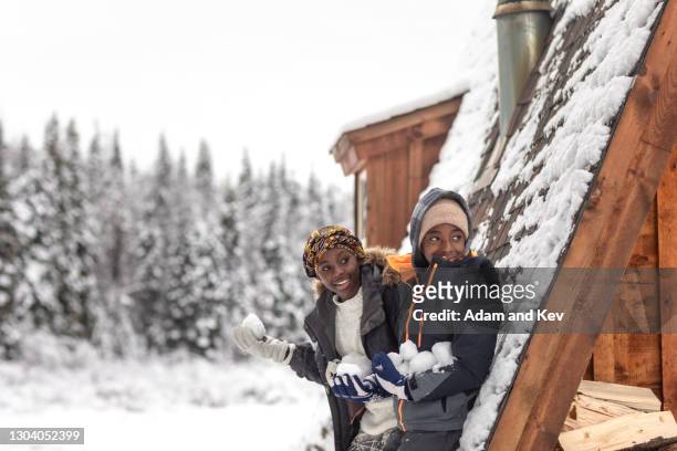 two children wait in hiding with snowballs for immanent ambush attack - bola de neve imagens e fotografias de stock