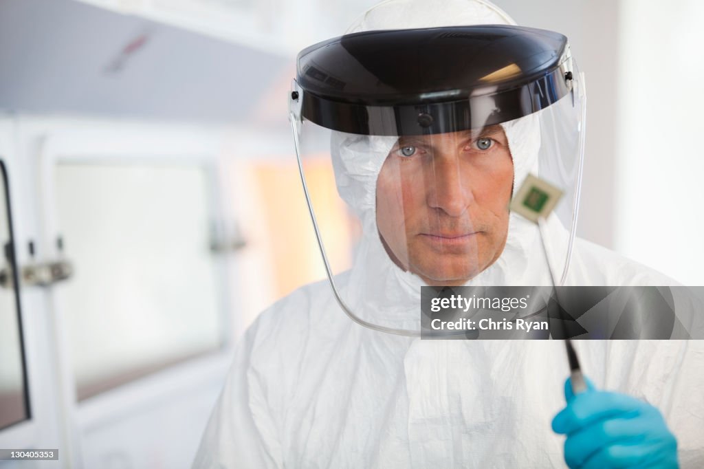 Scientist examining microchip in lab