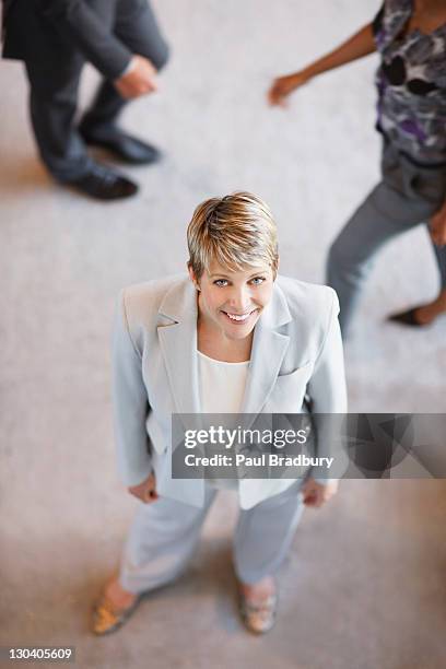 businesswoman smiling in office - elevated view portrait stock pictures, royalty-free photos & images