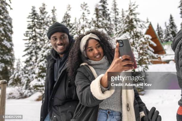 Attractive and stylish couple pose for selfie in winter