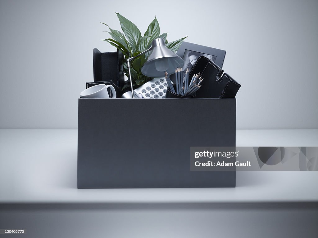 Box packed with desk objects