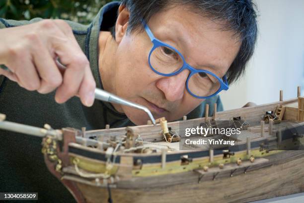 retirement hobby leisure - building wooden ship kit model - retirement community building stock pictures, royalty-free photos & images