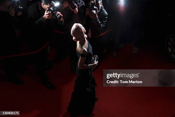 celebrity posing for paparazzi on red carpet - red carpet stock pictures, royalty-free photos & images