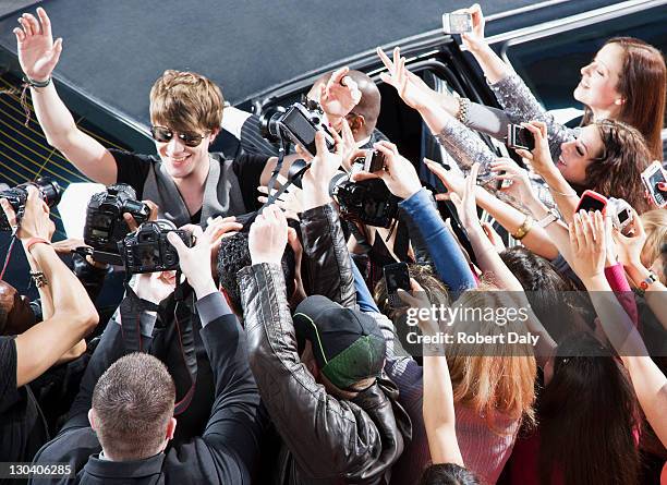 celebrity waving to paparazzi and fans - premiere event stock pictures, royalty-free photos & images
