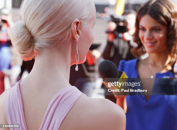 celebrity speaking to reporter on red carpet - journalist microphone stock pictures, royalty-free photos & images