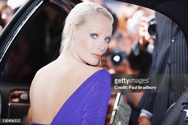 celebrity emerging from car towards paparazzi - fame stock pictures, royalty-free photos & images