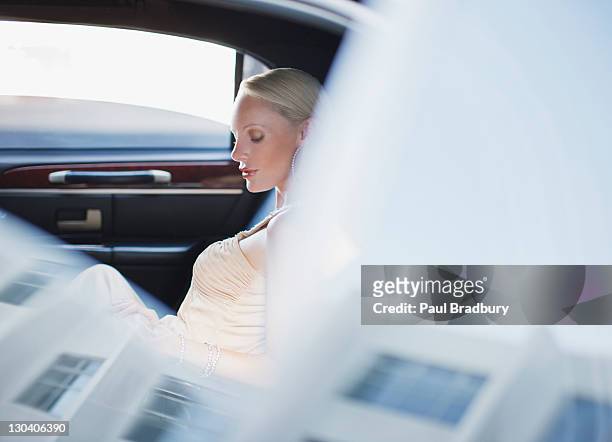 woman sitting in backseat of limo - red carpet limo stock pictures, royalty-free photos & images