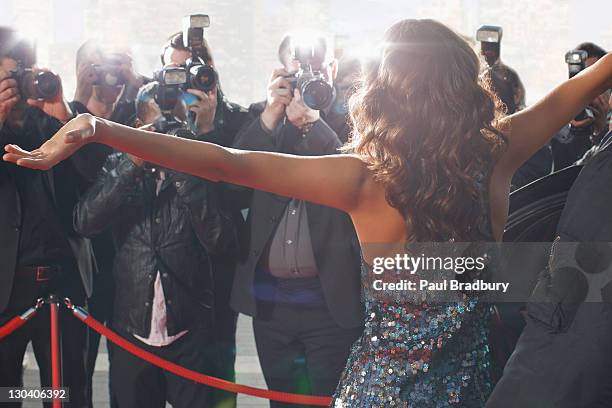 celebrity posing for paparazzi on red carpet - red carpet event celebrity stock pictures, royalty-free photos & images