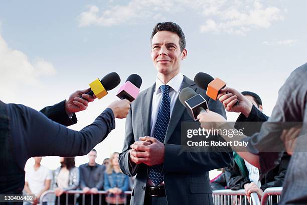 politician speaking to reporters - celebrity bildbanksfoton och bilder