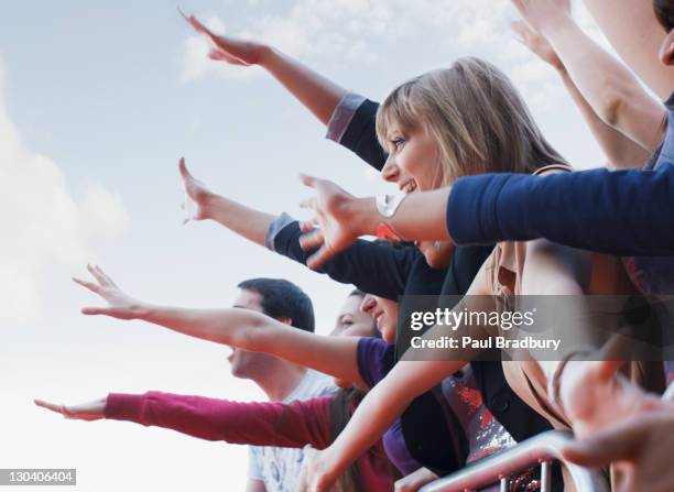 fans waving from behind barrier - rush world premiere red carpet arrivals stock pictures, royalty-free photos & images